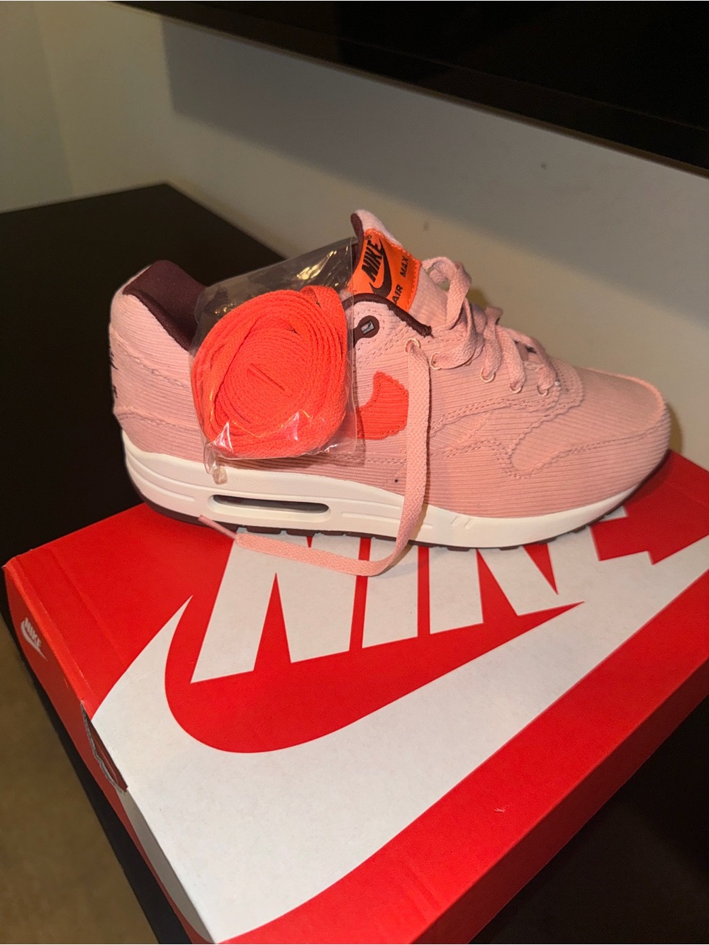 Nike Women’s Pink Sneaker with Orange Accents